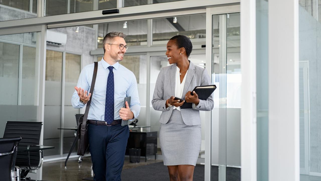 Business professionals discussing global e‑invoicing compliance in a modern office.